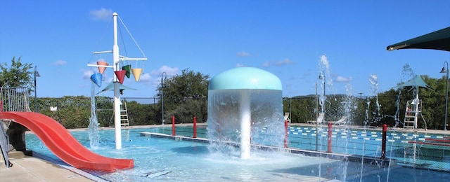 view of swimming pool featuring fence