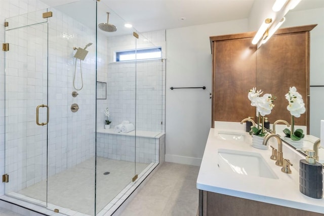 bathroom with a sink, baseboards, double vanity, and a shower stall