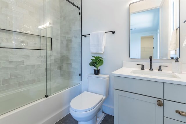 bathroom featuring vanity, toilet, and bath / shower combo with glass door