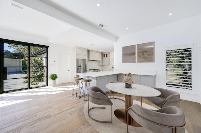 dining space with recessed lighting, visible vents, and light wood-style flooring