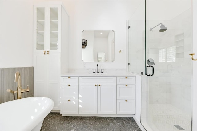 bathroom with visible vents, a stall shower, a freestanding bath, and vanity