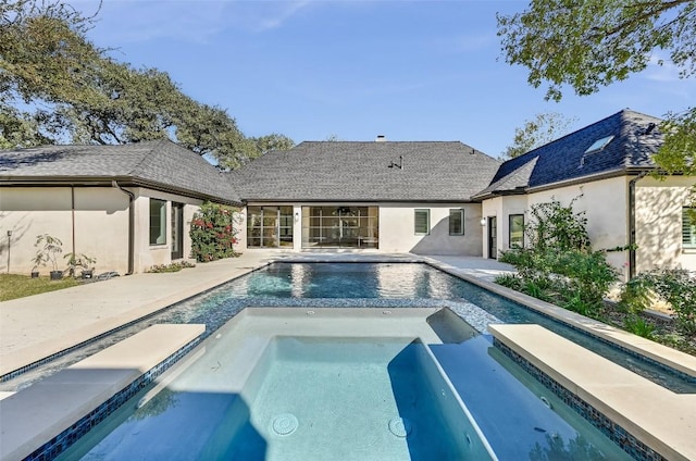 view of swimming pool featuring a patio area and a pool with connected hot tub