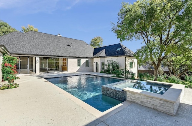 view of pool featuring a patio area and a pool with connected hot tub