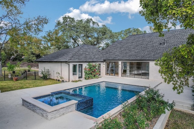 view of pool featuring a patio area, fence, a lawn, and a pool with connected hot tub