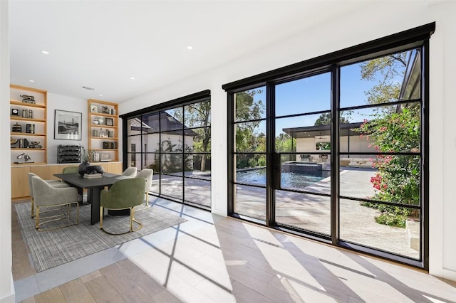 unfurnished dining area with recessed lighting and wood finished floors