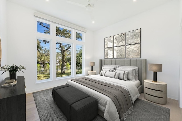 bedroom featuring light wood finished floors, recessed lighting, and baseboards