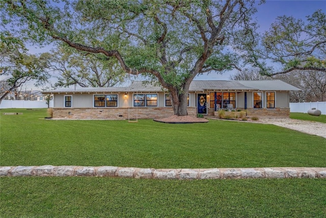 rear view of house featuring a yard and fence