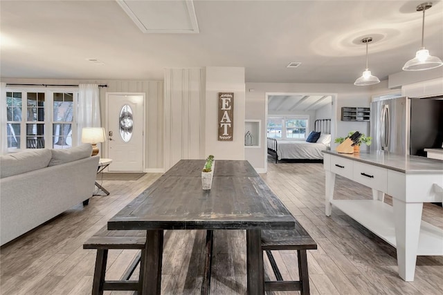 dining area featuring visible vents and light wood finished floors