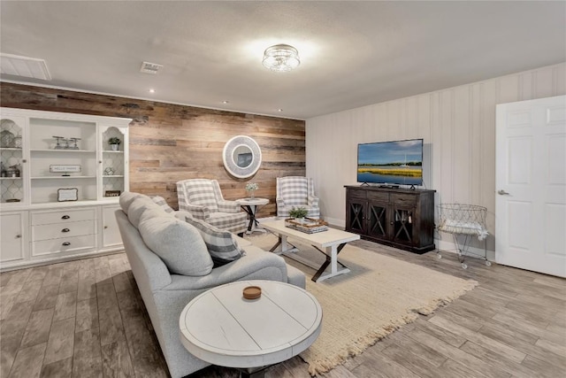 living room featuring visible vents and light wood-style flooring