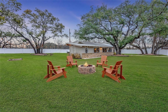 view of yard with a fire pit and a fenced backyard