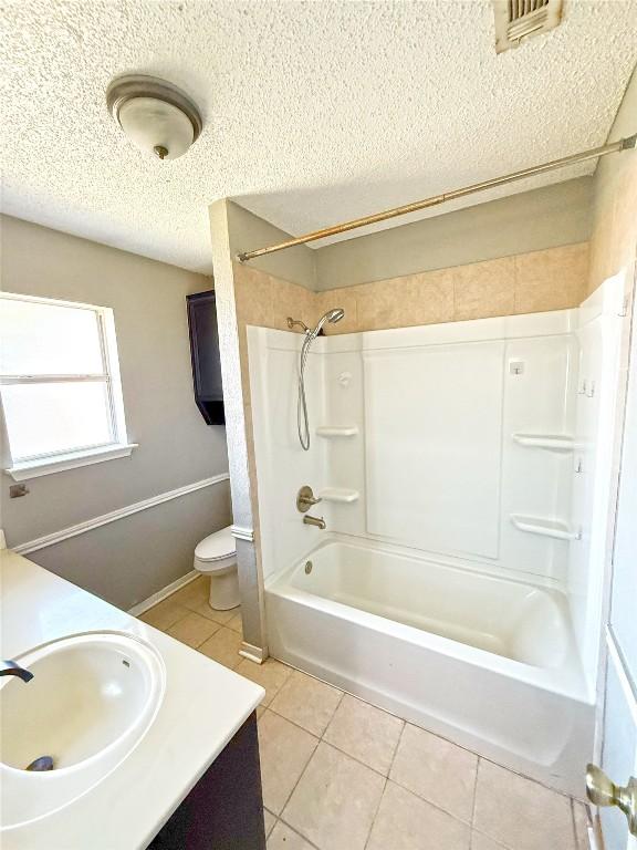 full bathroom featuring visible vents, shower / tub combination, a textured ceiling, tile patterned floors, and toilet