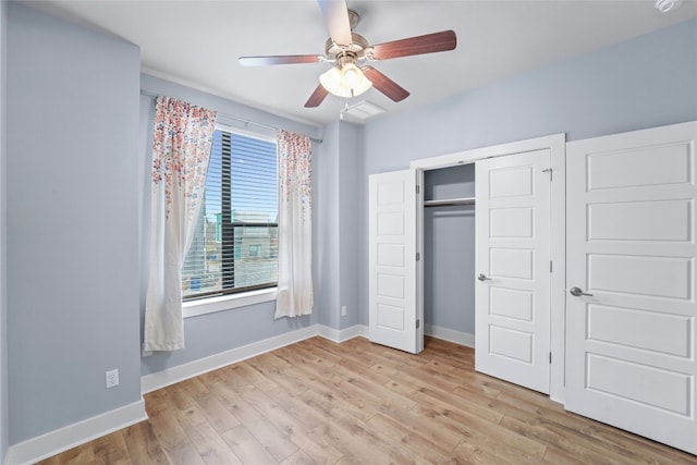 unfurnished bedroom with a closet, baseboards, light wood-style floors, and ceiling fan