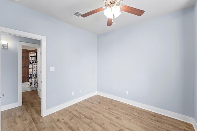 unfurnished room with light wood-style flooring, visible vents, baseboards, and ceiling fan