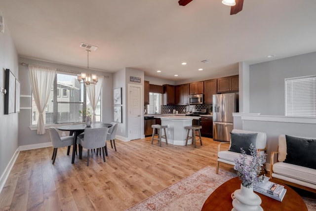 dining area featuring visible vents, plenty of natural light, and light wood-type flooring