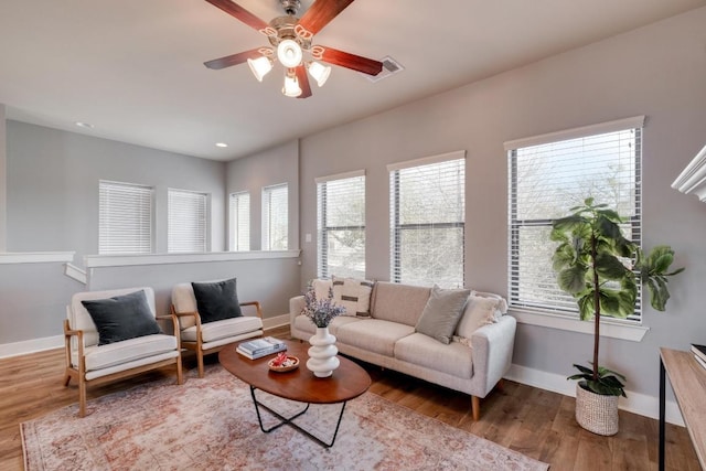 living room with recessed lighting, a ceiling fan, baseboards, and wood finished floors