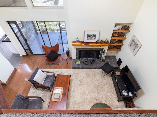 living room featuring wood finished floors and a tile fireplace