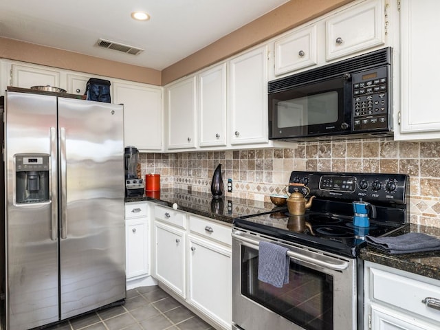 8200 Neely Dr Unit 250, Austin, TX 78759 - kitchen with stainless steel appliances, white cabinets, light tile patterned floors, backsplash, and dark stone countertops