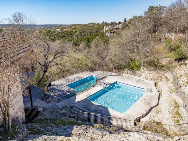 view of swimming pool with a patio area and fence