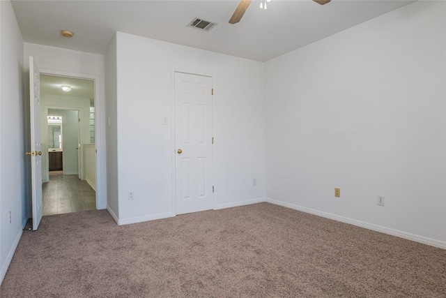 unfurnished bedroom featuring a ceiling fan, baseboards, visible vents, and carpet floors