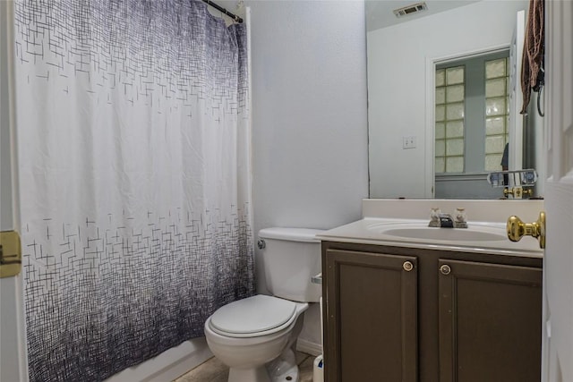 bathroom featuring visible vents, toilet, vanity, and a shower with curtain