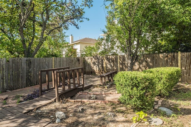 view of yard with a deck and a fenced backyard