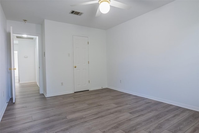 unfurnished bedroom featuring visible vents, baseboards, wood finished floors, and a ceiling fan