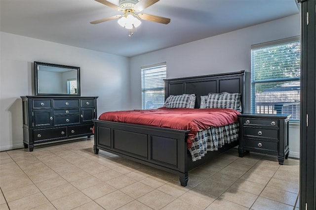 bedroom with light tile patterned floors, baseboards, and ceiling fan