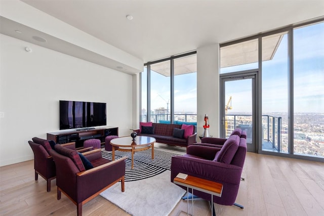 living room featuring a wall of windows, wood finished floors, and baseboards