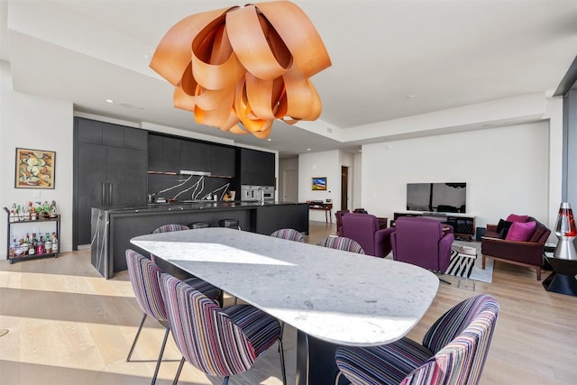 dining area with recessed lighting and light wood-style floors