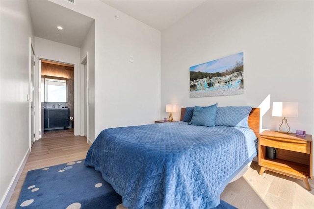 bedroom featuring baseboards and wood finished floors