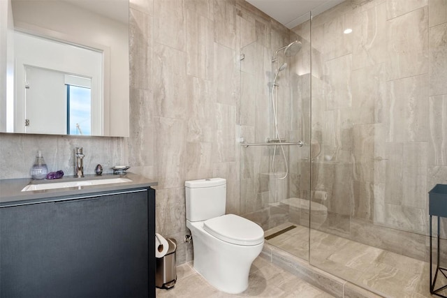 bathroom featuring tiled shower, toilet, tile walls, and vanity