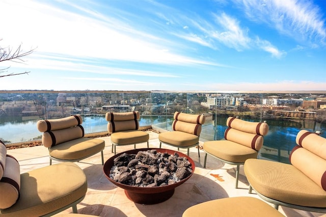 view of patio / terrace featuring a city view and a fire pit