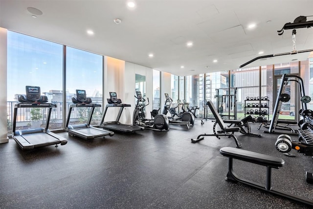 gym with a wall of windows