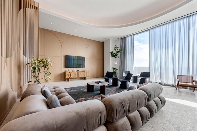 living room featuring a wall of windows and recessed lighting