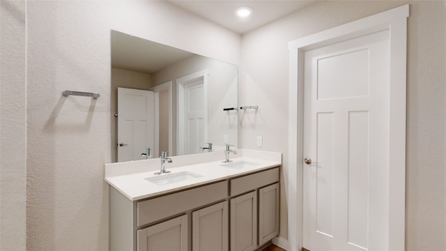 full bath with double vanity and a sink