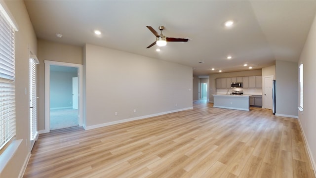 unfurnished living room featuring recessed lighting, light wood-type flooring, baseboards, and ceiling fan