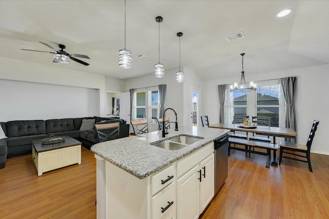 kitchen with a sink, visible vents, light wood-style floors, and dishwasher