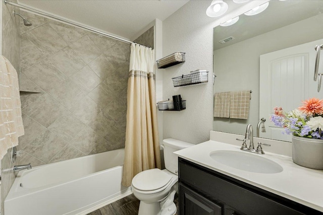 bathroom featuring visible vents, toilet, wood finished floors, vanity, and shower / bathtub combination with curtain