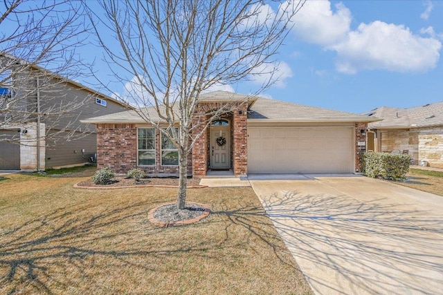 view of front of house featuring a front lawn, an attached garage, brick siding, and driveway