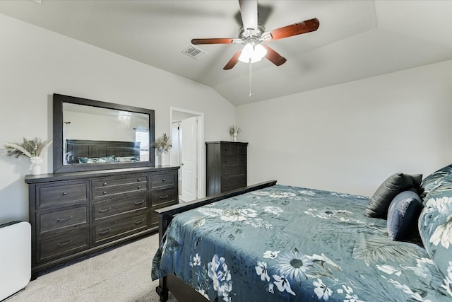 bedroom featuring visible vents, light colored carpet, ceiling fan, and vaulted ceiling