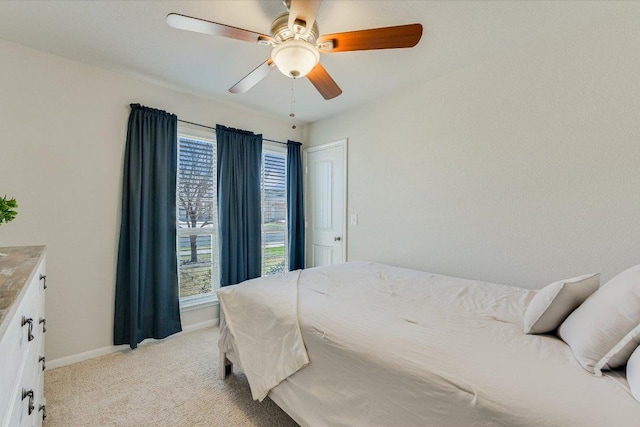 bedroom with baseboards, light carpet, and ceiling fan