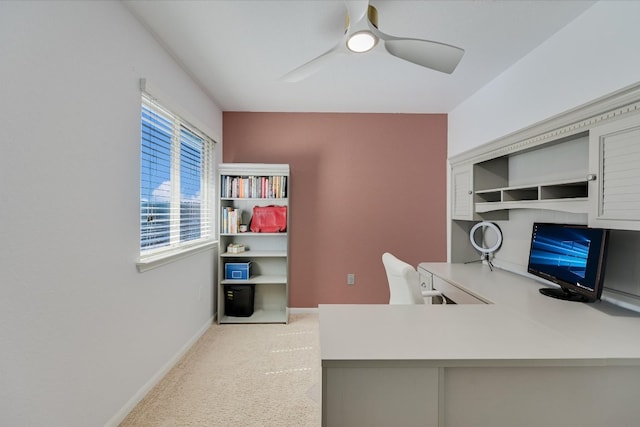 home office featuring light carpet, baseboards, and ceiling fan