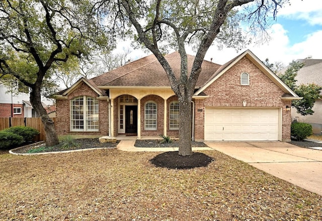 single story home with fence, driveway, roof with shingles, a garage, and brick siding