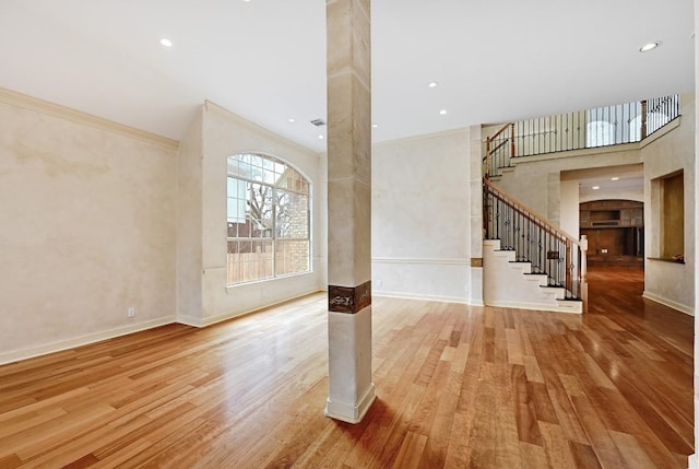 foyer with ornamental molding, wood finished floors, recessed lighting, baseboards, and stairs