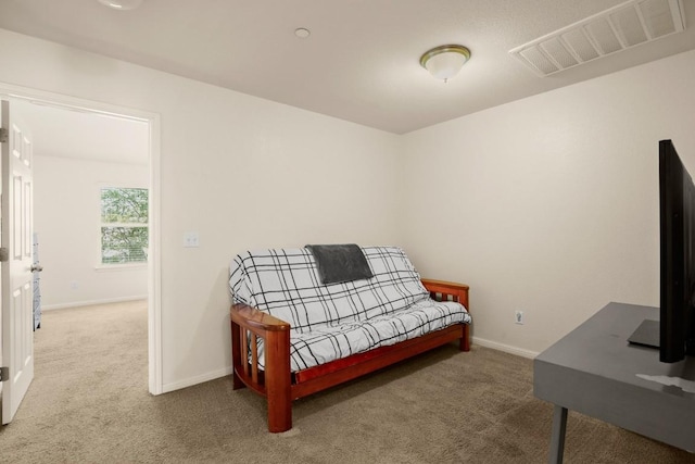 carpeted bedroom featuring visible vents and baseboards