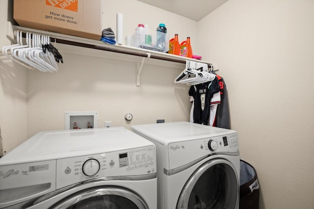 clothes washing area with washer and dryer and laundry area