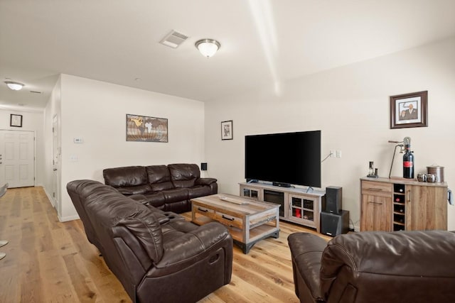 living area featuring visible vents and light wood finished floors