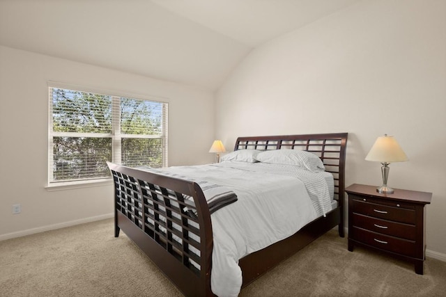 carpeted bedroom with baseboards and vaulted ceiling