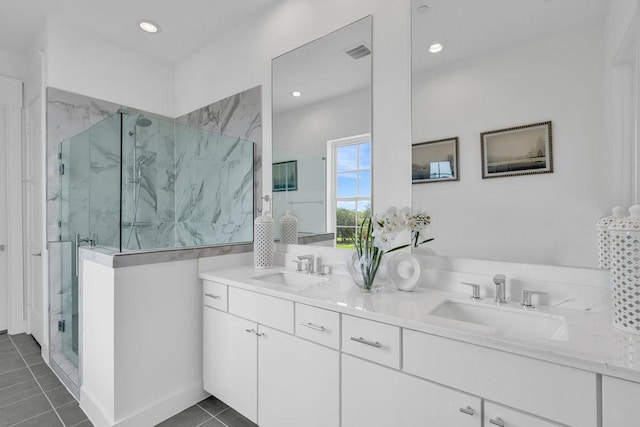 full bathroom with double vanity, visible vents, a marble finish shower, and a sink