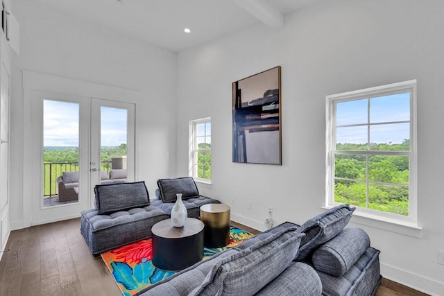 living area featuring hardwood / wood-style floors, beamed ceiling, french doors, and baseboards